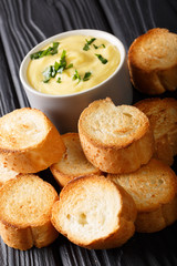 Homemade toasted bread and cheese sauce close-up. vertical