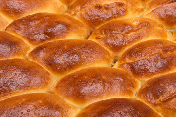 Homemade turnovers with filling are prepared  Latin American style. Concept of wheat spikes home brewing close-up as a background