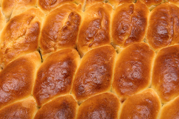 Homemade turnovers with filling are prepared  Latin American style. Concept of wheat spikes home brewing close-up as a background