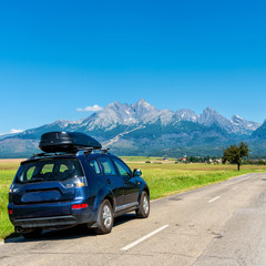 car for traveling with a roof rack on a mountain road