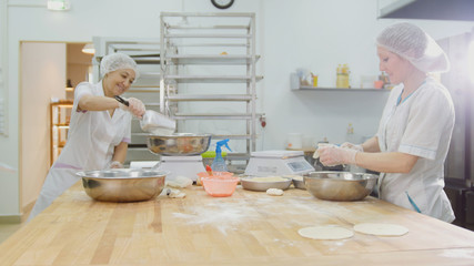 The employees female in the bakery makes fresh bread
