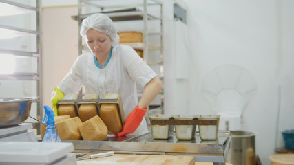 Female bakes bread on commercial kitchen