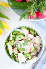 Salad with radish, cucumber and egg, top view, selective focus