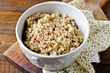 Boiled quinoa in a bowl on a wooden table