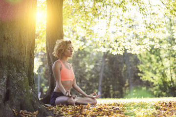 Young woman practicing yoga in nature.