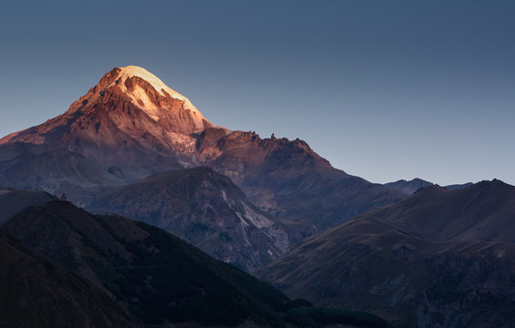 sunrise over Mount Kazbek in greater caucasus mountains