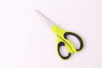 Green and black colour scissors isolated on white