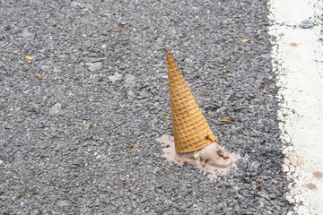 Icecream on the ground. (selective focus)., chocolate icecream cone dropped on the concrete floor...