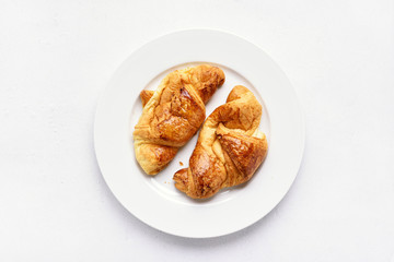 Croissants on plate, top view