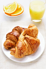 Fresh hot croissants and orange juice