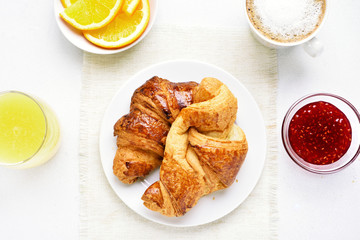 Tasty breakfast with croissants, top view