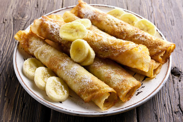 Thin pancakes, crepes roll with banana slices