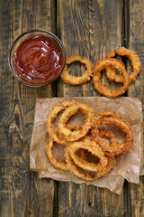 Onion rings with tomato sauce, top view