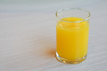 Orange juice on wooden table