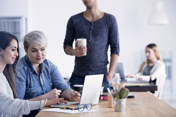 Businesswomen working together using laptop