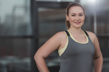 Fototapeta na wymiar Portrait of obese girl smiling in gym
