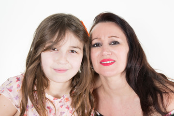 Mother tenderly hugging daughter in white background