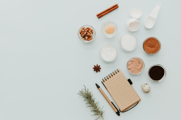 Ingredients for baking cake, creative flat lay composition over pastel background