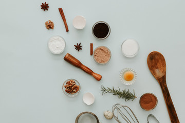 Ingredients for baking cake, creative flat lay composition over pastel background