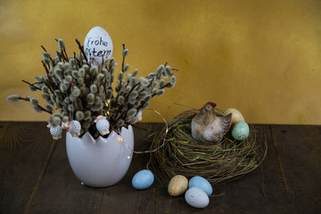 Palm kitten bouquet with easter nest on wooden background