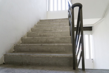 Old staircase with a handrail in a building., lonely concept. goal concept.
