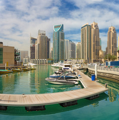 Dubai - The skyscrapers of Marina and the promenade with the yachts.