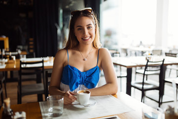 Woman drinking coffee in restaurant