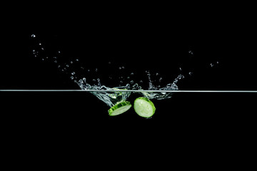 Fototapeta na wymiar cucumber in water with splash
