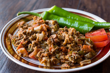 Turkish Street Food Kokorec with Tomato and Green Pepper. (Portion Sheep Bowel)