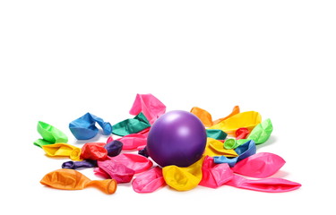 Pile of deflated and inflated colorful balloons, isolated on white background