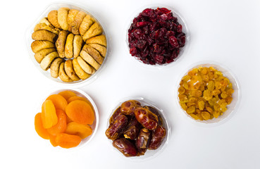 Various dried fruits in small bowls top view