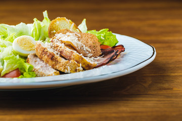 close-up view of delicious caesar salad on wooden table