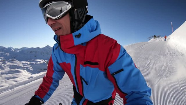 one male skier skiing on sunny winter day off piste in fresh deep snow in 4K selfie point of view
