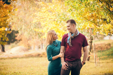 love, relationship, and people concept - smiling couple hugging in autumn park