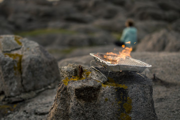 Close up of the orange fire burning in the small grill isolated, soft focus. Norway.