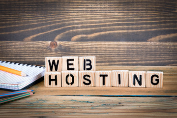 web hosting. Wooden letters on the office desk, informative and communication background.