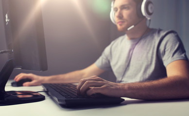 close up of man playing computer video game