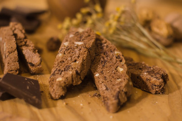 bread with candied fruit, chocolate and nuts close up picture, wooden table background