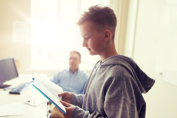 Fototapeta premium student boy with notebook and teacher at school
