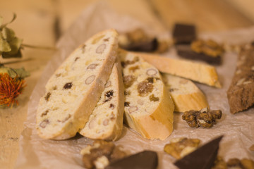 bread with candied fruit, chocolate and nuts close up picture, wooden table background