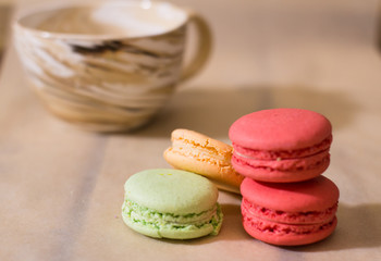 colorful macaroons on wooden background 