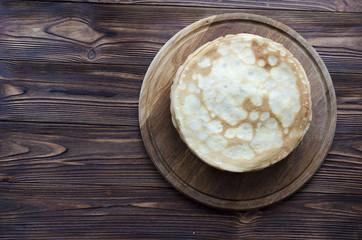 pile of pancakes on wooden background