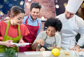 happy friends and chef cook baking in kitchen