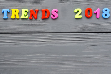 word "trends"  from plastic magnetic letterson grey wooden background