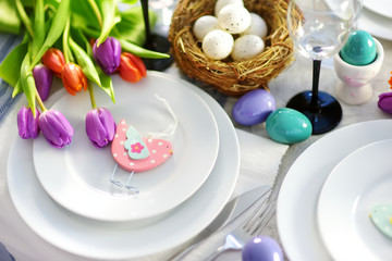 Beautiful table setting with crockery and flowers for Easter celebration