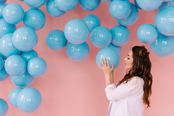 Girl in a pink room with blue balls