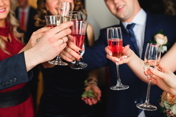 happy friends with glasses of champagne celebrate the wedding