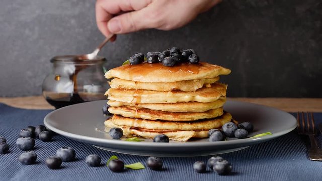 hd video shows how to prepare fluffy american pancakes with extra blueberry topping and syrup