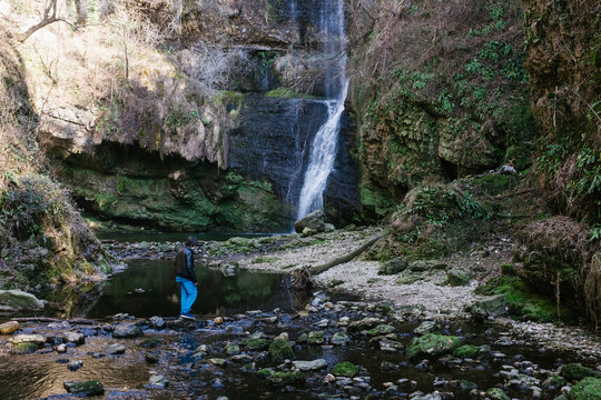 12 year old boy walking near Fermona waterfall Ferrera, Italy