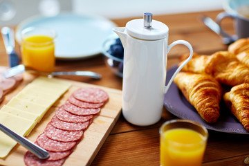 coffee pot and food on served table at breakfast